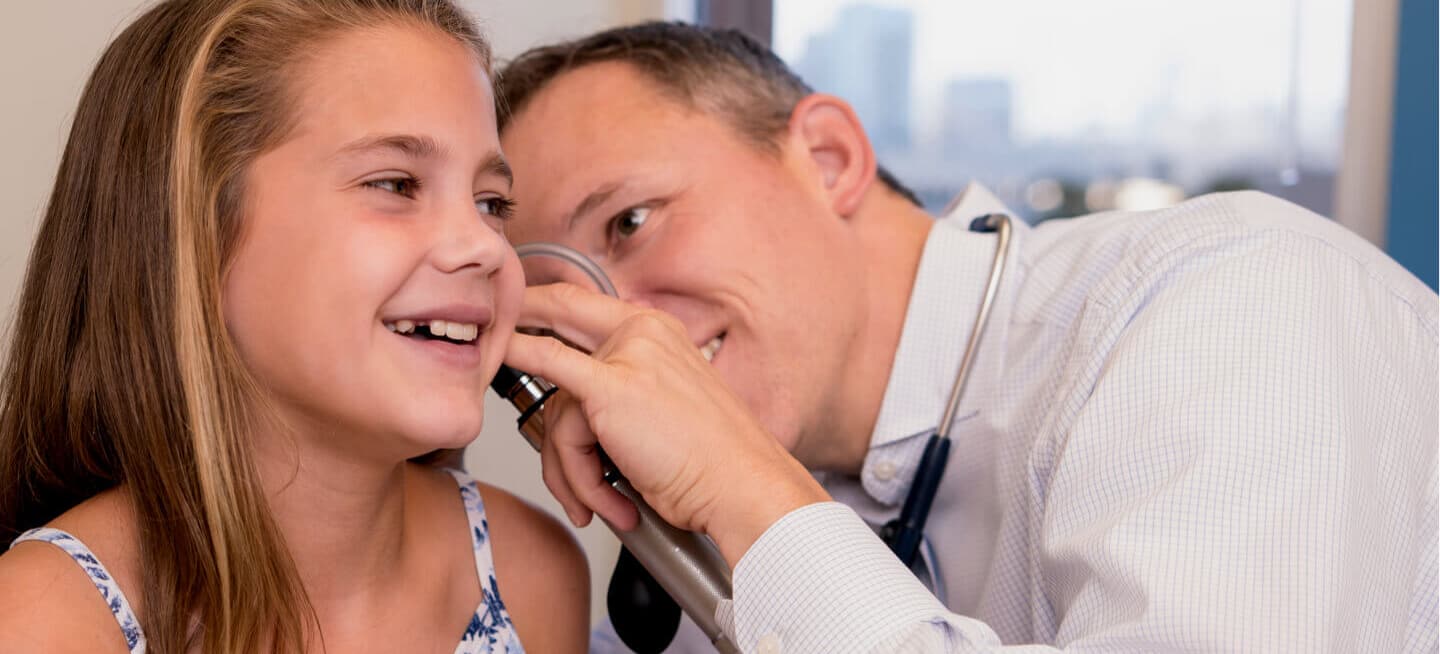 Doctor examines a young girl patient